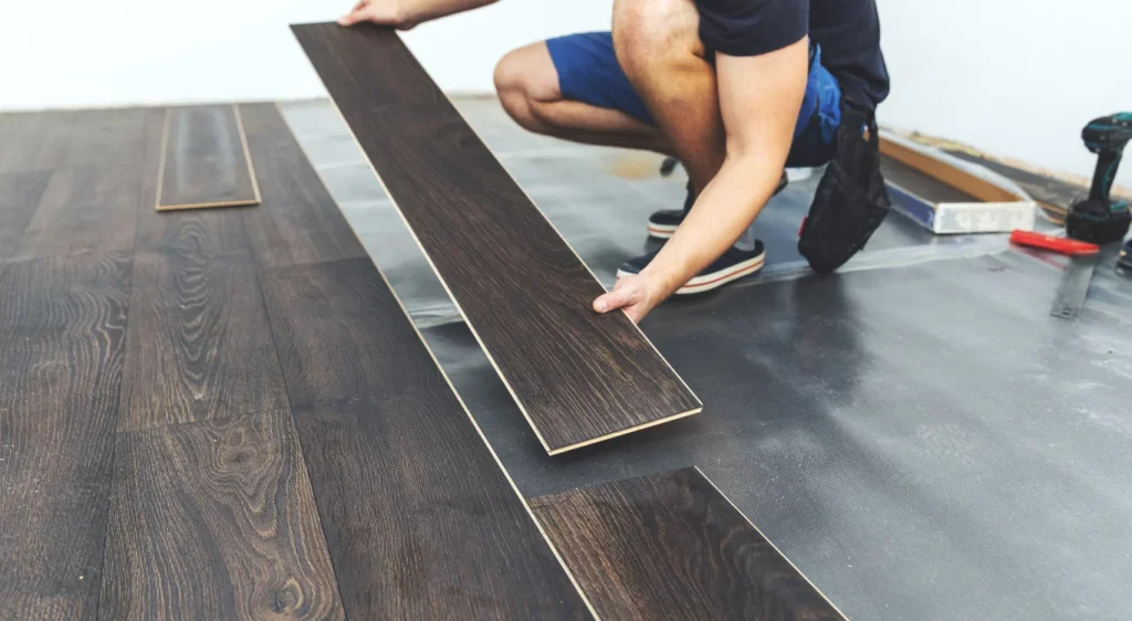 Man installing LVP luxuary vynal planks